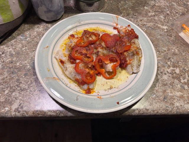 A plate featuring a baked lake trout recipe.