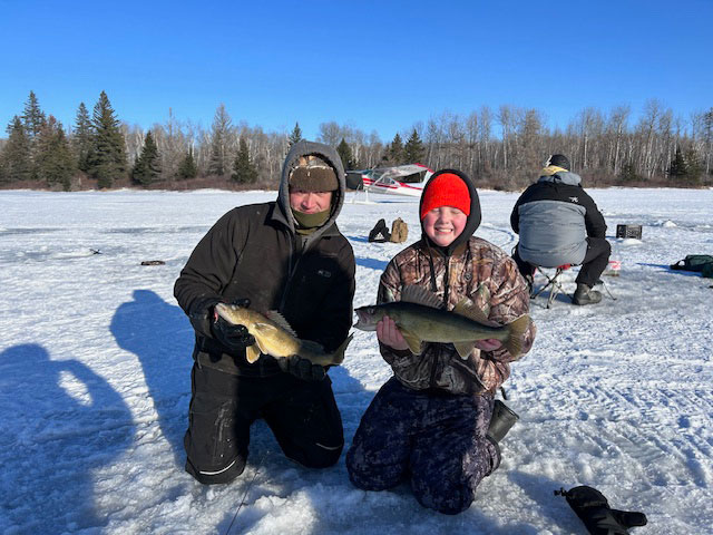 2 fishermen holding walleye