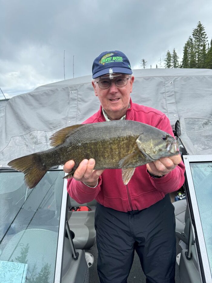 Abe holding up a beautiful smallmouth bass