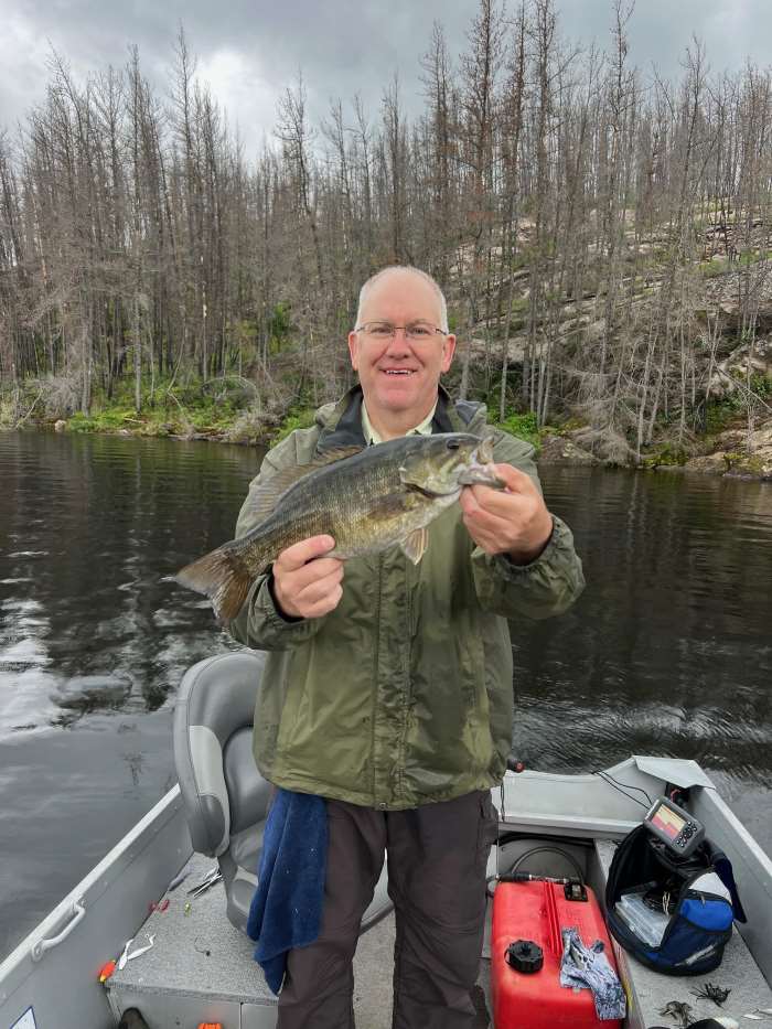 Jim holding a smallmouth bass from Rex Lake Outpost.