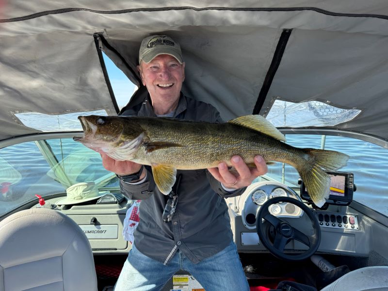 Don holding big walleye caught on Umfreville Lake.