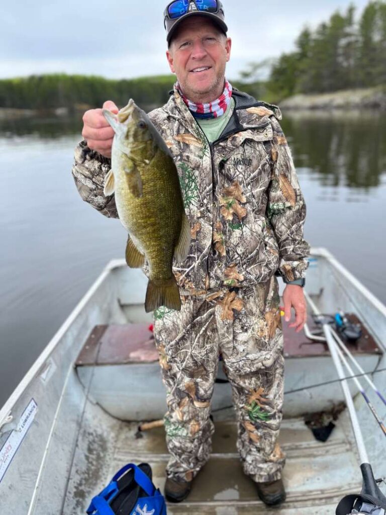 Man Holdings up smallmouth bass at Rex Lake Outpost