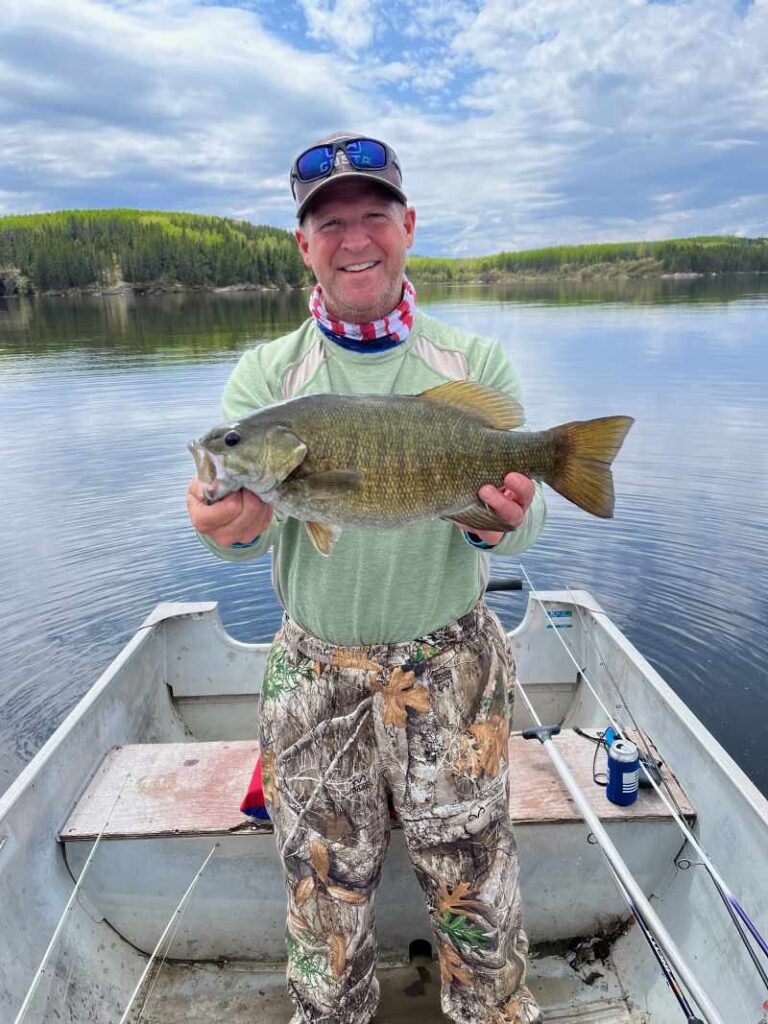 Big smallmouth bass being held in boat on Rex Lake