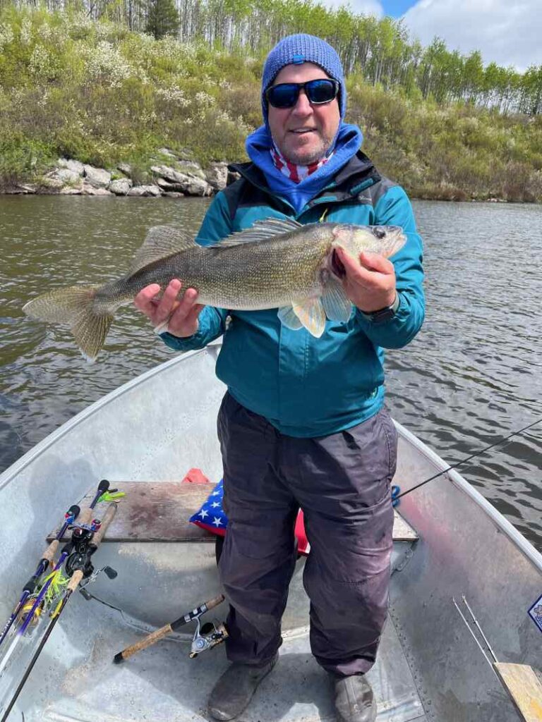 Fisherman holding up big walleye from Little Rex Lake.