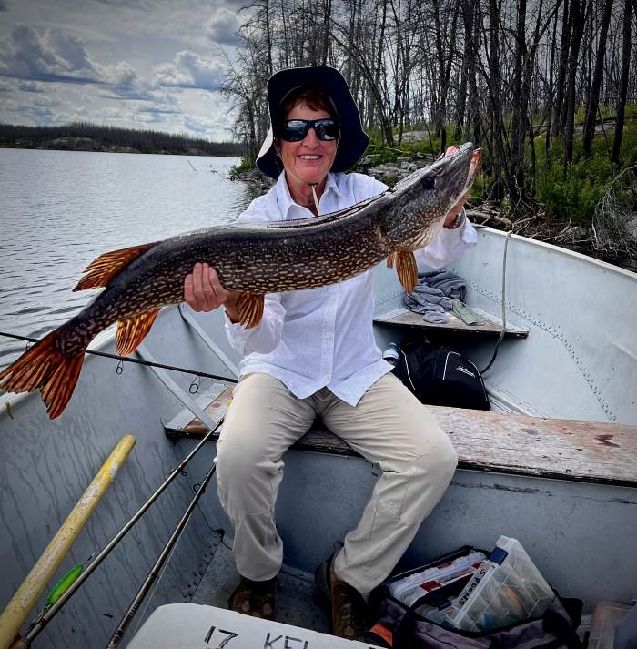 Cary holding up her big pike while on a daily flyout lake.