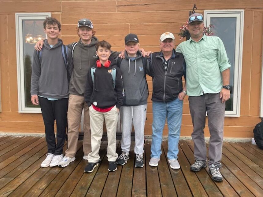 Family photo in front of Halley's Camps One Man Lake Lodge.