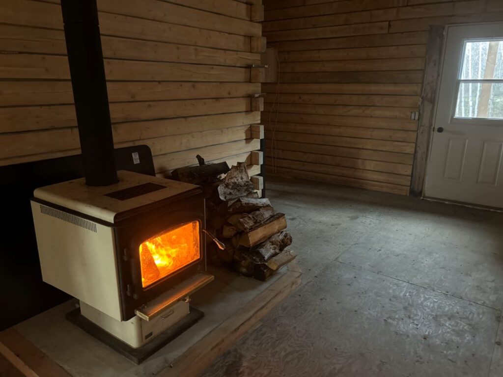 Dufualt's interior picture of cabin with wood stove