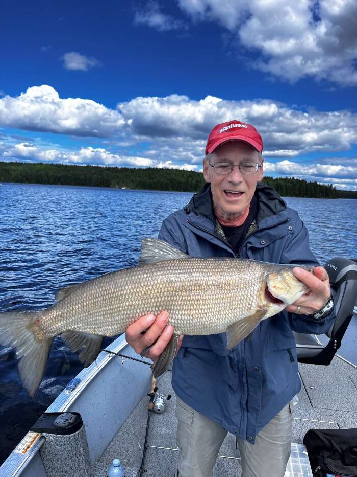 Man holding a white fish