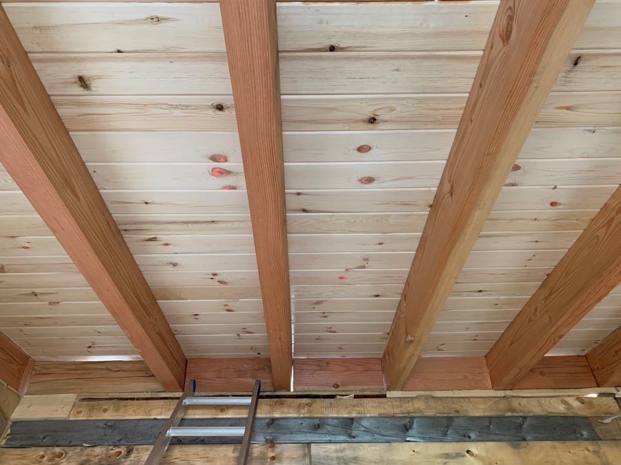 Interior picture of Dufault's Island Outpost roof with wood rafters cut from sawmill.