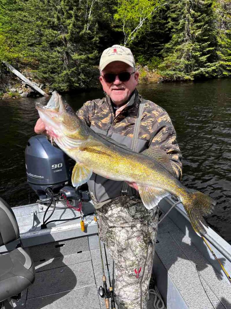 Jeff holding up a large northern that he caught at Halley's Camps!