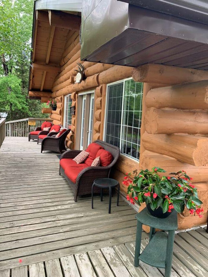 The deck view of Kettle Falls showing the red outside chairs awaiting fishermen after a day's fish on the lake.