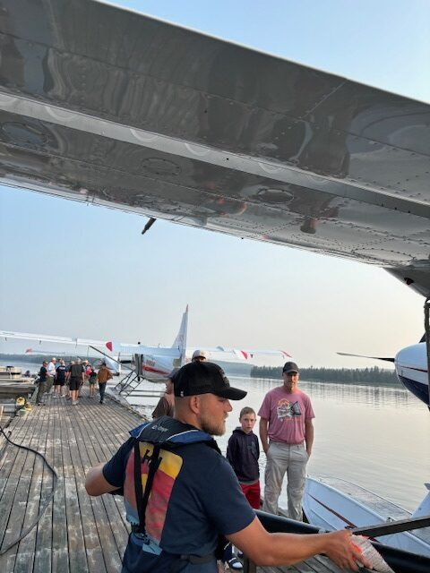 Halley's Camps pilot loading the plane for our fishing customers.