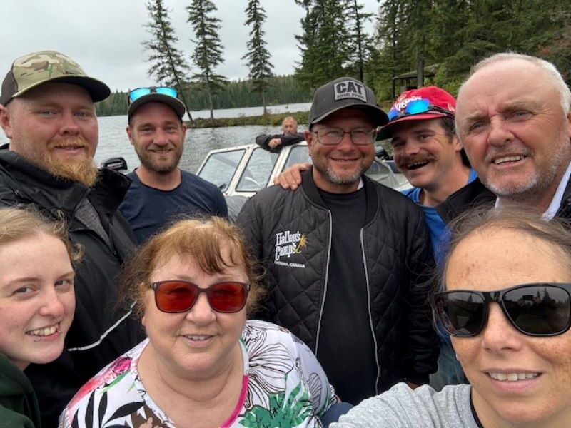 Kettle Falls staff group photo standing by dock before getting in the boat and leaving.