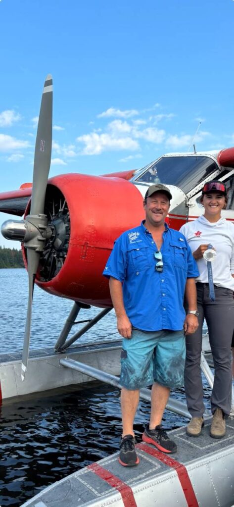 Chris and Olympic Medalist Abby standing by float plane heading fishing!