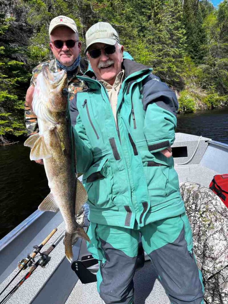 Fishing buddies fishing walleye from a boat on the English River at Halley's Camps!