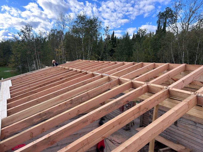 New roof with wood laid out for trusses on Halley's Camps Dufault's Island Outpost.