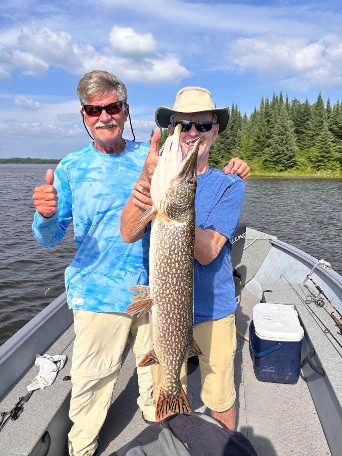 Biran and Bob fishing large northern pike trophies at Kettle Falls Lodge.