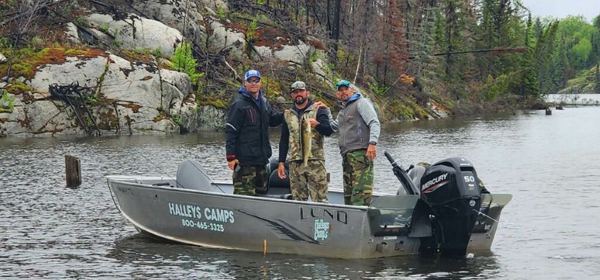 3 friends fishing in a boat at Halley's Camps.